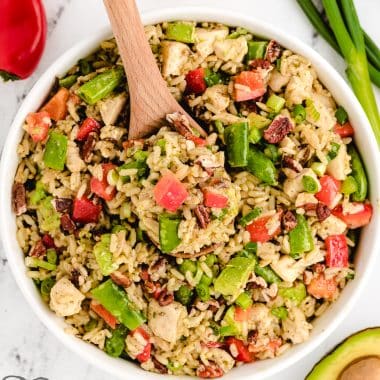 cold lemon chicken wild rice salad with a wooden spoon