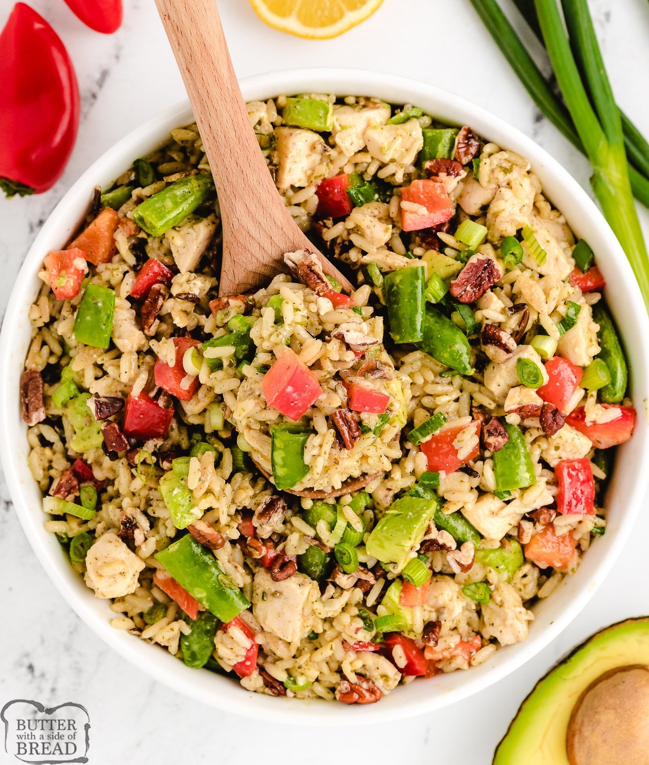 cold lemon chicken wild rice salad with a wooden spoon