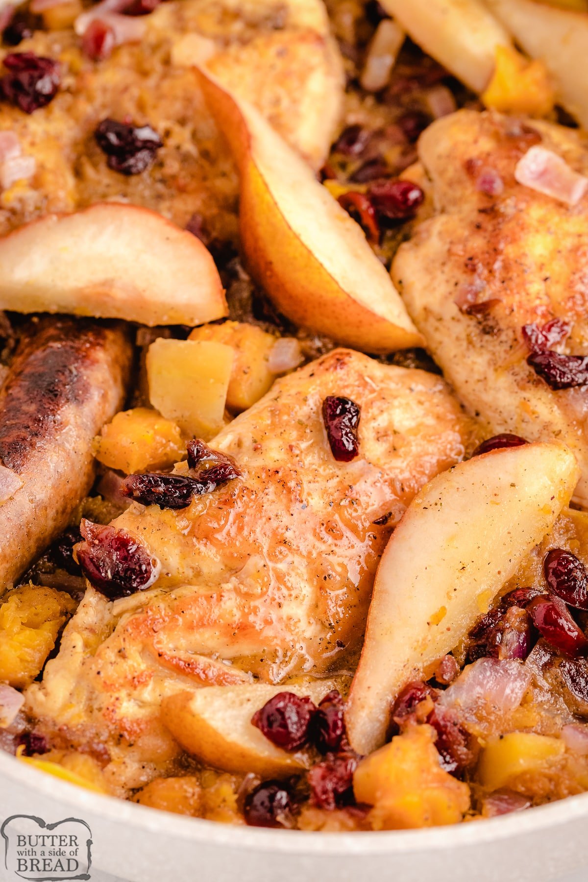 braised chicken in a pan with apples