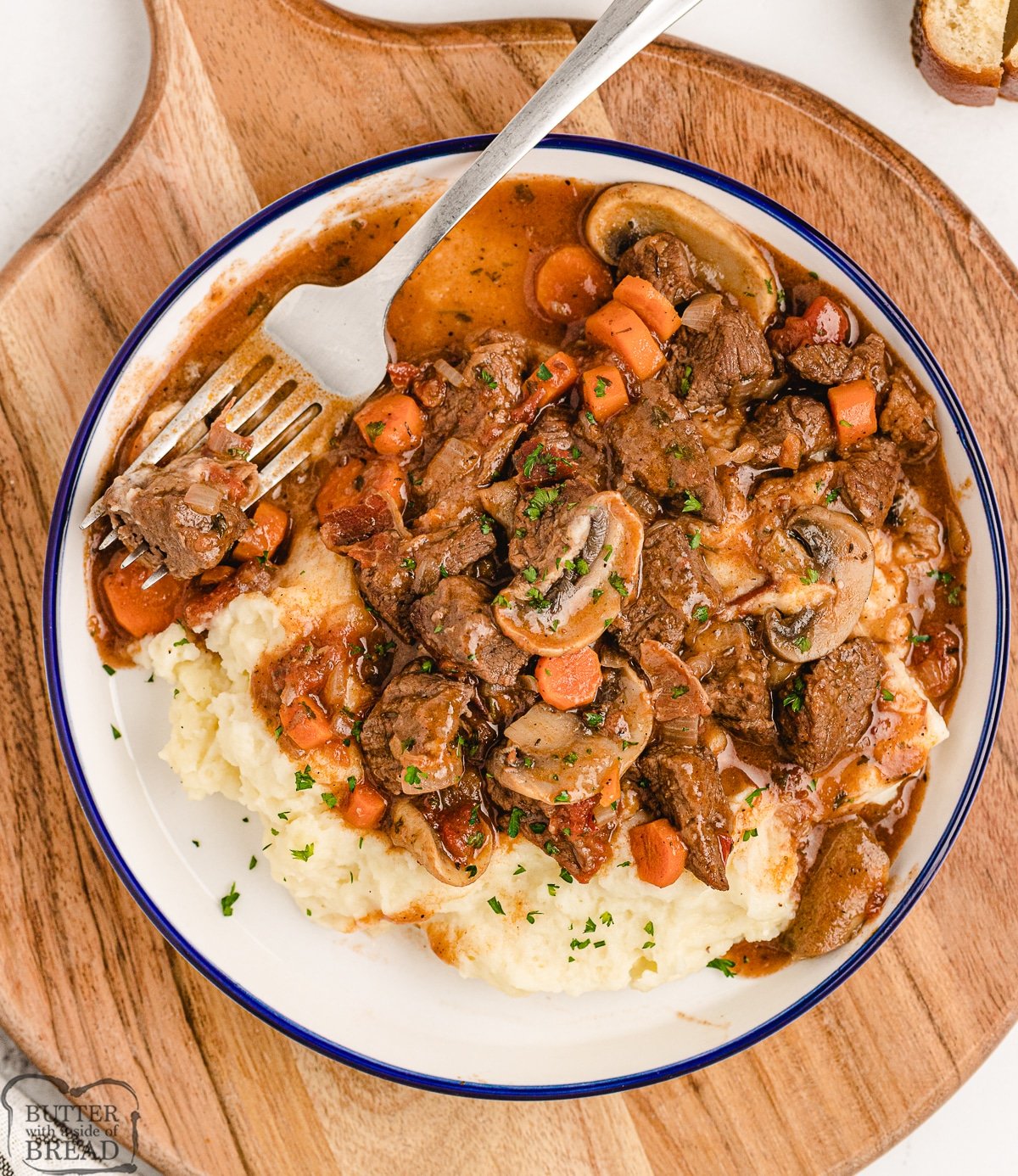 plate of beef bourguignon over mashed potatoes