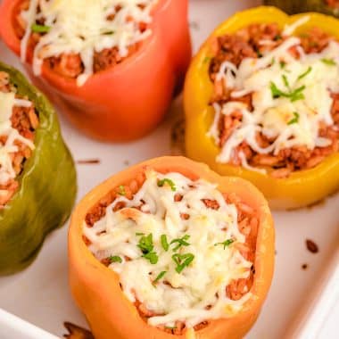 stuffed bell peppers in a white baking dish