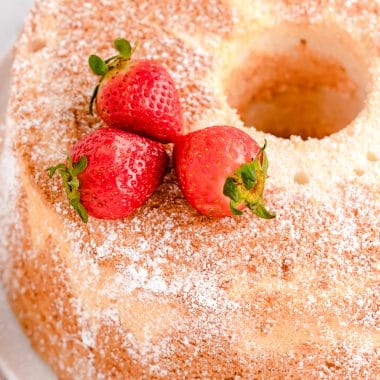 homemade angel food cake with strawberries on top