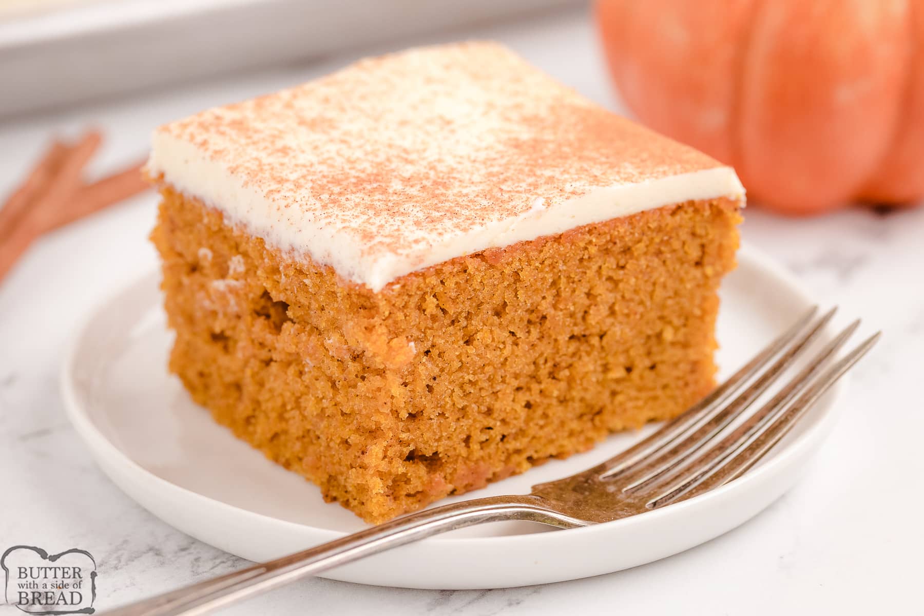 square pumpkin bars with cream cheese frosting and dash of cinnamon