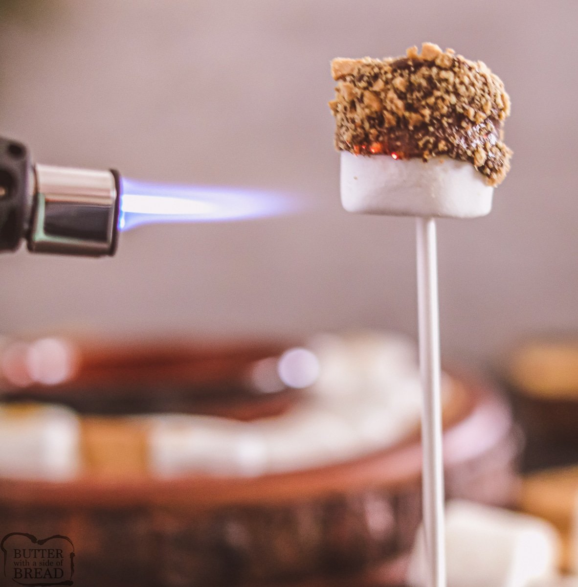 using a butane torch to toast a marshmallow
