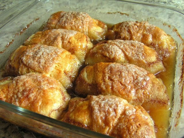 Country Apple Dumplings made easy with few ingredients- an apple, brown sugar, crescent dough & lemon lime soda! Simple recipe for apple dumplings in caramel sauce that everyone loves.