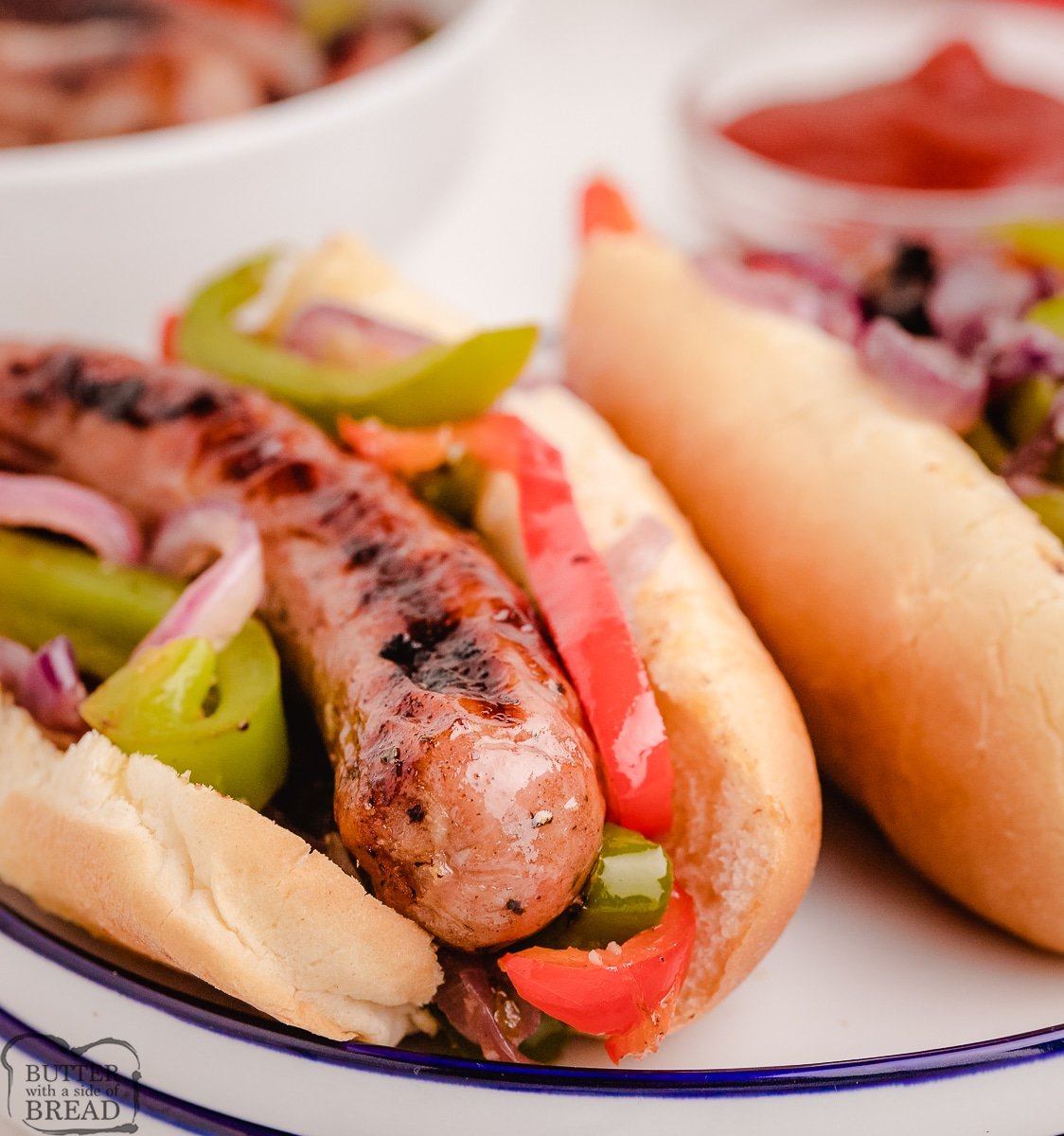 grilled sausages with peppers on a bun