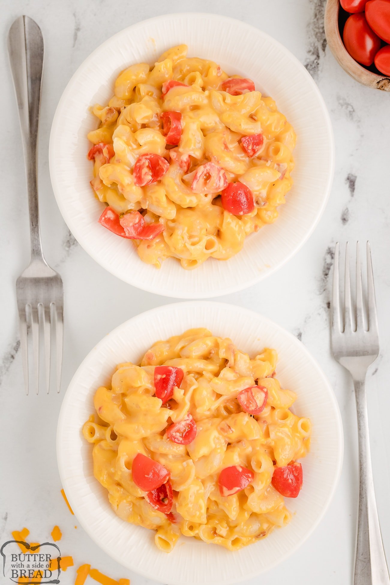 two servings of tomato bacon mac and cheese in bowls