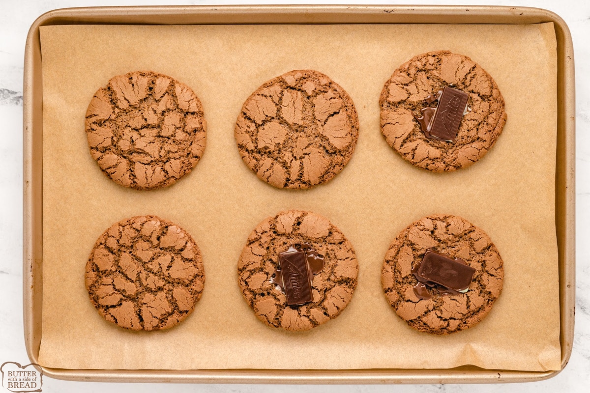 Placing Andes mint on top of each baked cookie. 