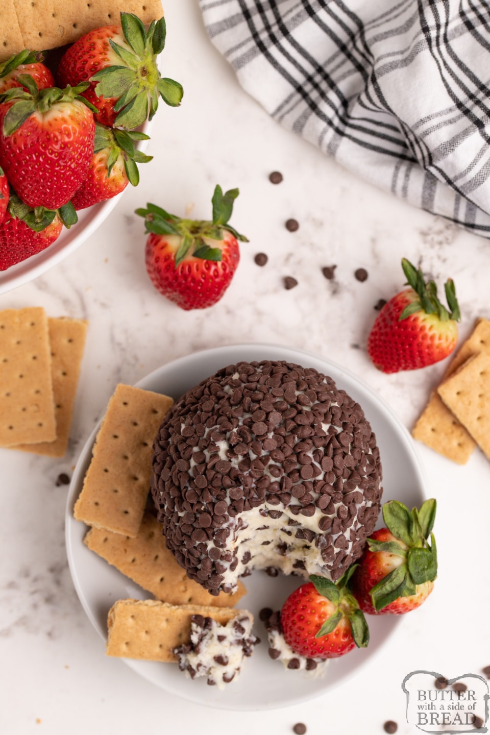 Cheesecake Cheese Ball recipe made with only 5 ingredients for an easy appetizer! This chocolate chip cheesecake cheese ball pairs perfectly with fresh strawberries and graham crackers and only takes a few minutes to make!
