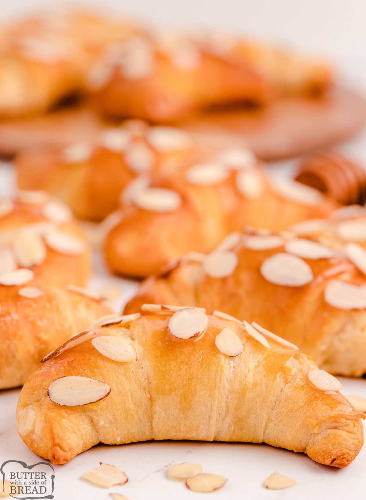 tray of honey crescent rolls with almonds