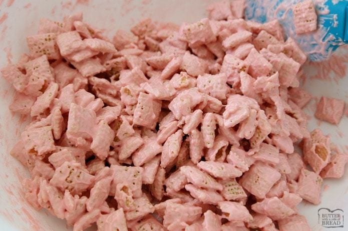 Strawberry Valentine Chex Mix is easy to make, fun & perfectly festive for Valentines Day! Strawberry white chocolate coating on Chex cereal with added chocolate candy is the perfect sweet treat!