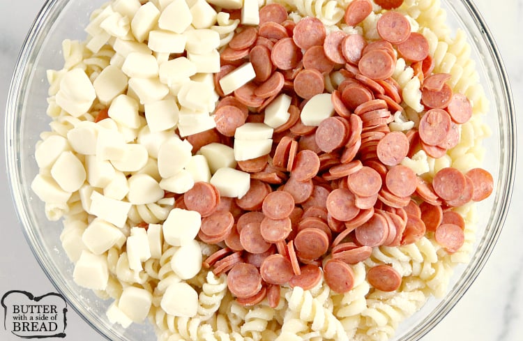 Pizza Pasta Salad is easy to make and full of pepperoni, mozzarella cheese, olives and all of your other favorite pizza toppings! This pasta salad is perfect for parties and potlucks!