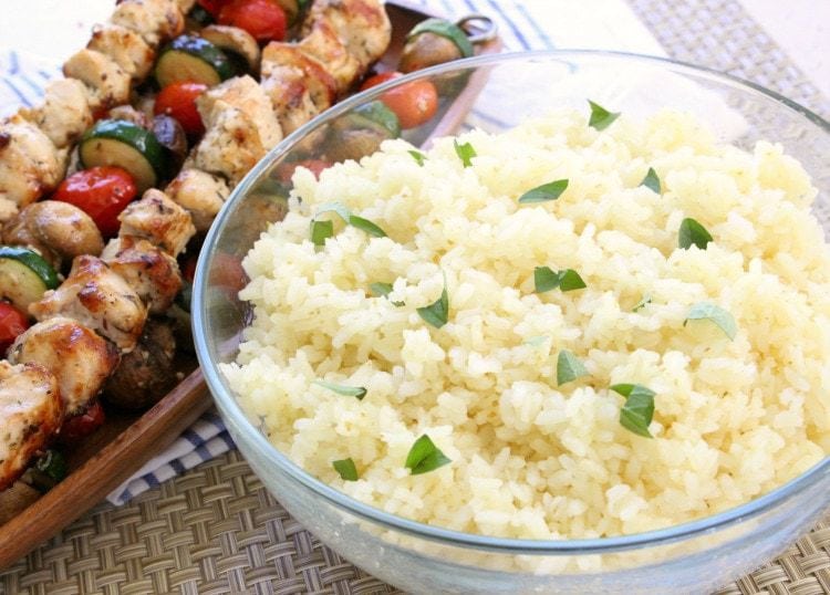 Simple recipe for Greek Chicken Souvlaki grilled to perfection and served with Greek lemon rice. Perfect weeknight dinner for anyone who loves the fresh, bright flavors of Greek food.