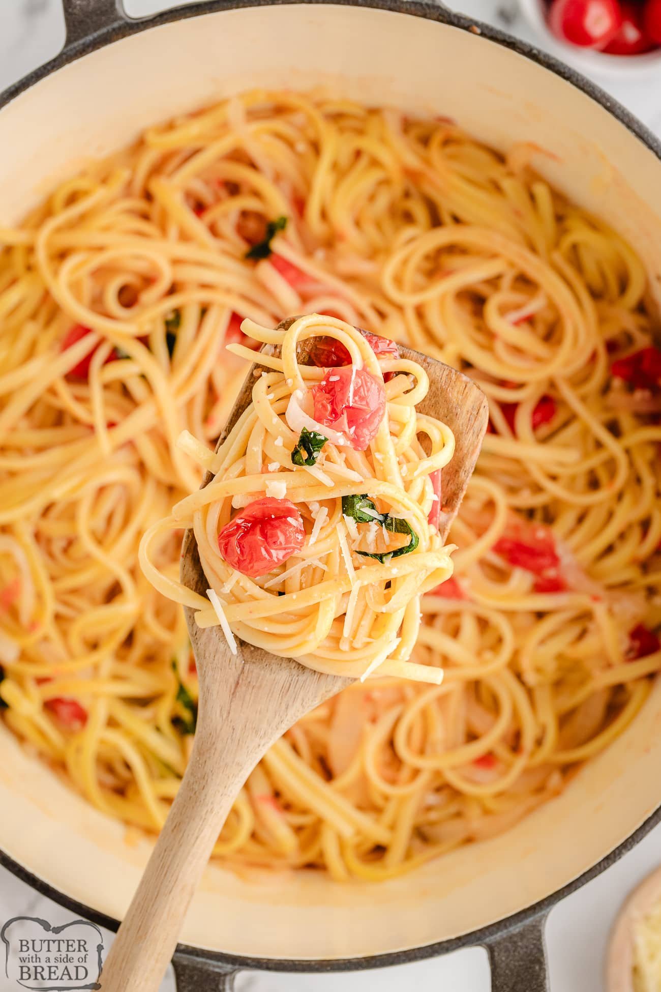 scooping out a serving of Martha's one pot pasta with tomatoes and basil