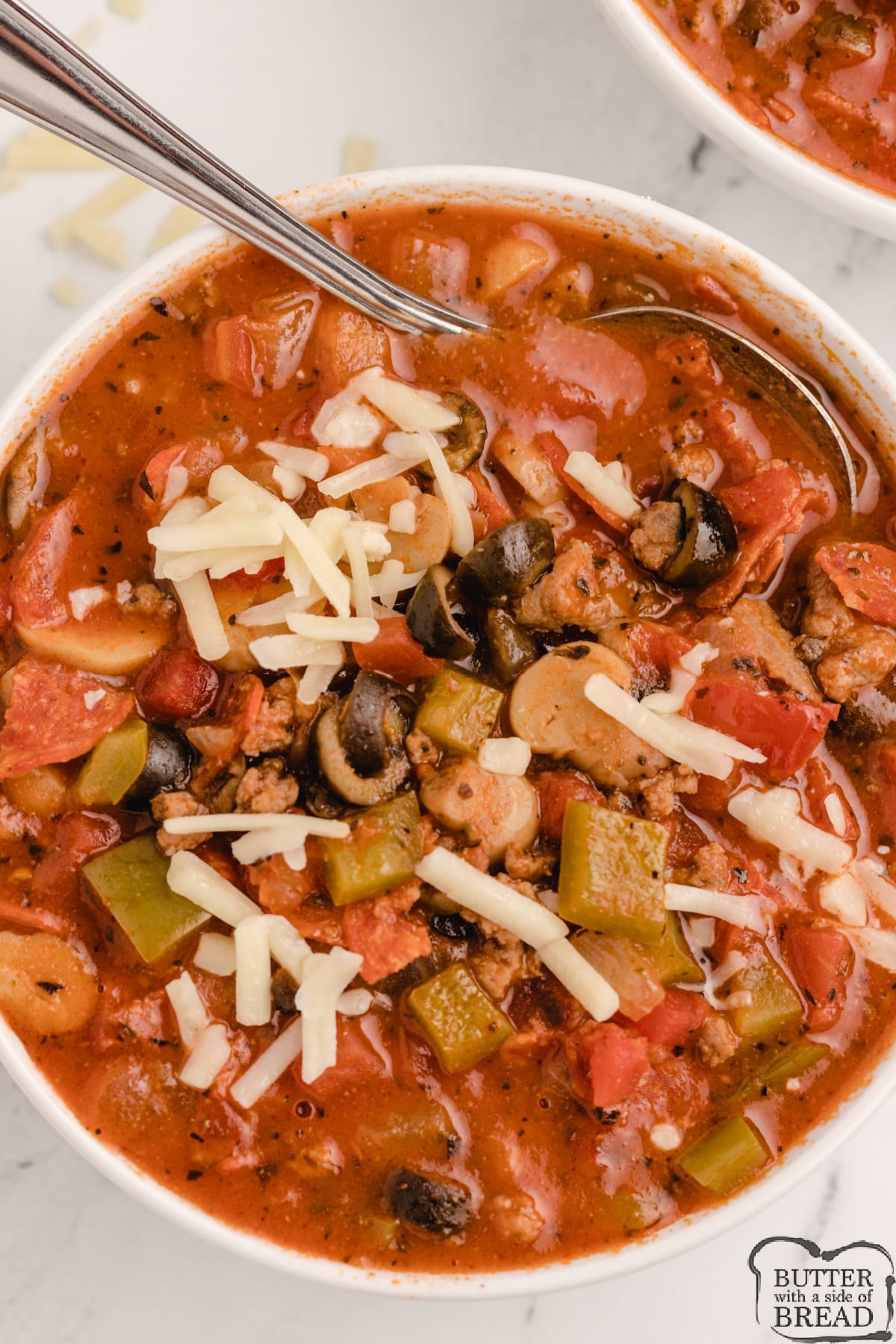 Slow Cooker Pizza Soup is a filling and comforting soup that is full of your favorite pizza flavors. Making this slow cooker pizza soup recipe  is so simple - combine the ingredients and the crockpot does all the work! 