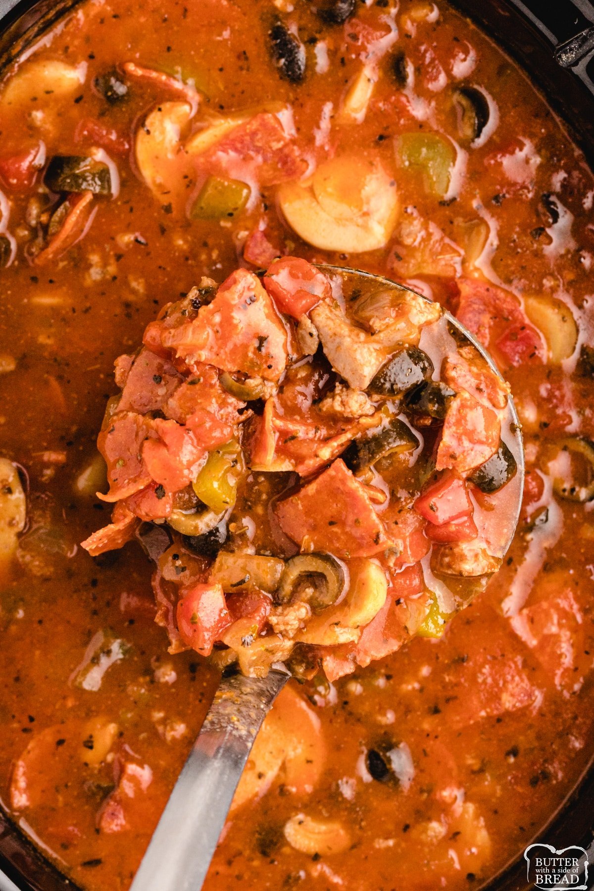 Crockpot soup recipe made with tomato soup, olives, peppers, sausage and pepperoni