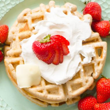 oatmeal cinnamon waffles with whipped cream and strawberries