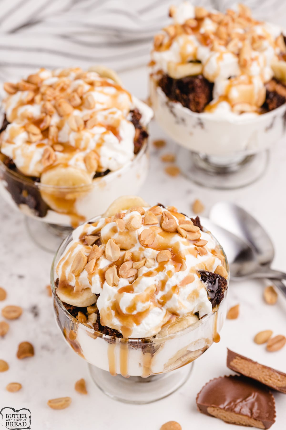 Brownie trifles with bananas, caramel, whipped cream and peanuts