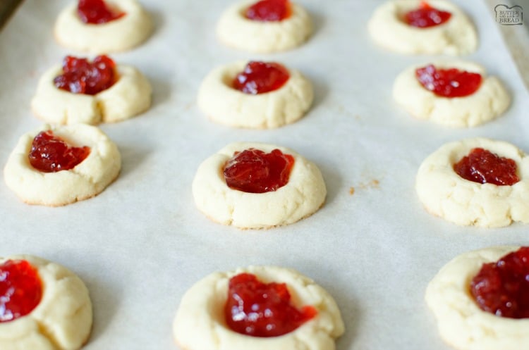 Easy recipe for Soft Jam Thumbprint Cookies perfect for the holidays! Buttery cookies with great flavor, filled with your favorite sweet jam. Perfect for Christmas cookie exchanges! 