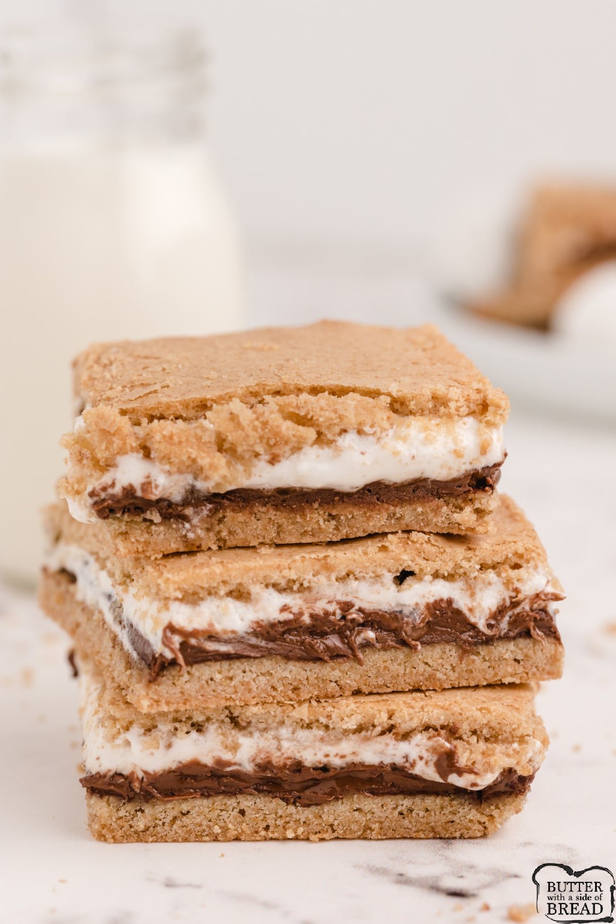 Baked S'mores Bars made with layers of homemade graham cracker crust, melted Hershey bars and marshmallow creme. Delicious s'mores dessert that is even better than the campfire version! 