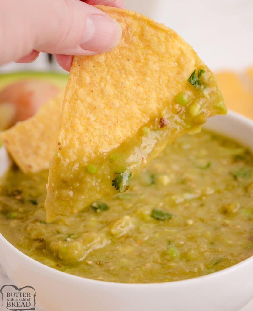 chip dipped in salsa verde with avocado