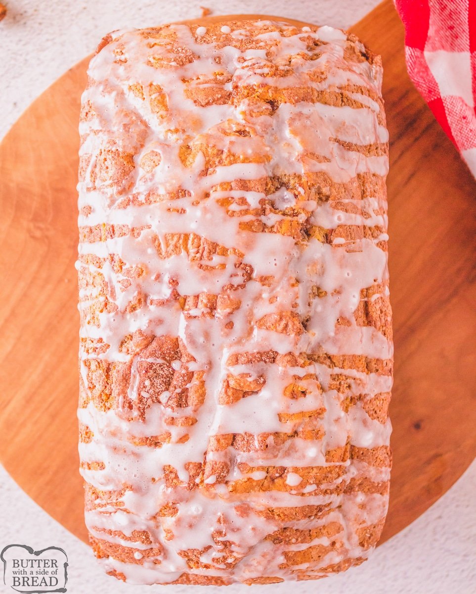loaf of cinnamon roll quick bread with vanilla glaze on top