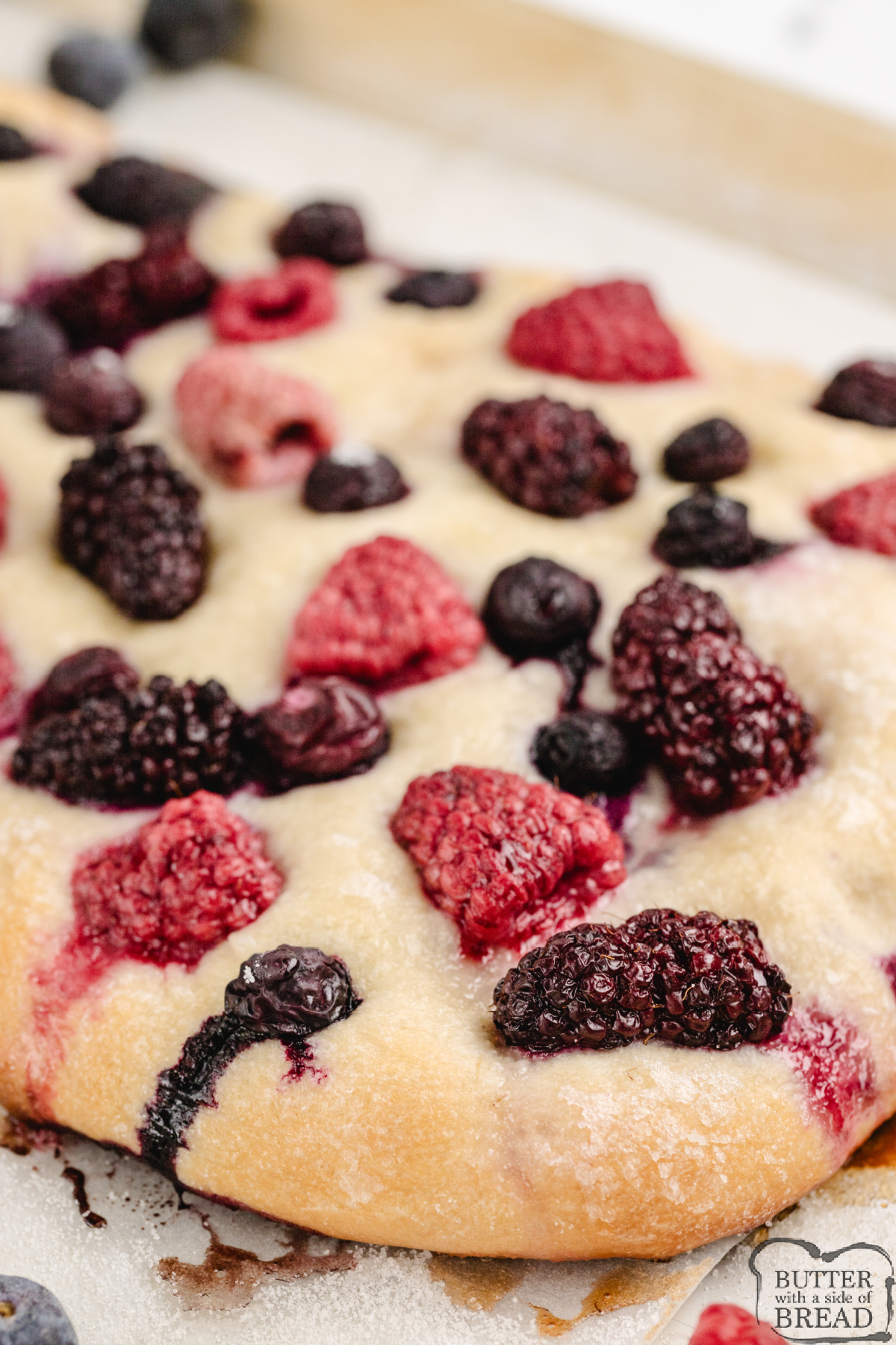 Triple Berry Focaccia is made with fresh berries and premade bread dough. Only 5 ingredients to make this unique bread that is perfect for breakfast or dessert!