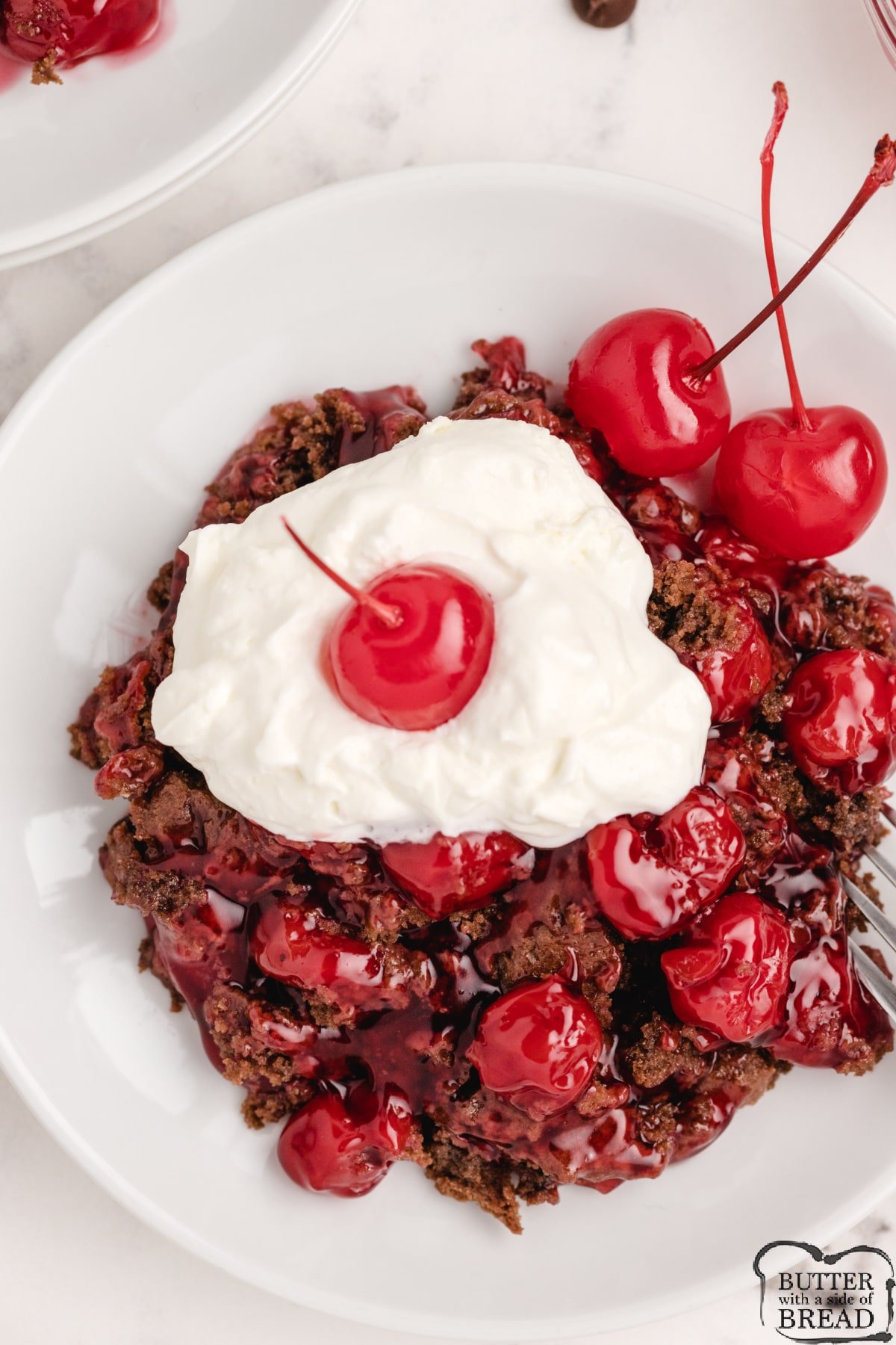 Chocolate Cherry Cobbler is a tasty variation on the traditional cherry cobbler recipe. Canned cherry pie filling baked with a simple crust made with melted chocolate chips. 
