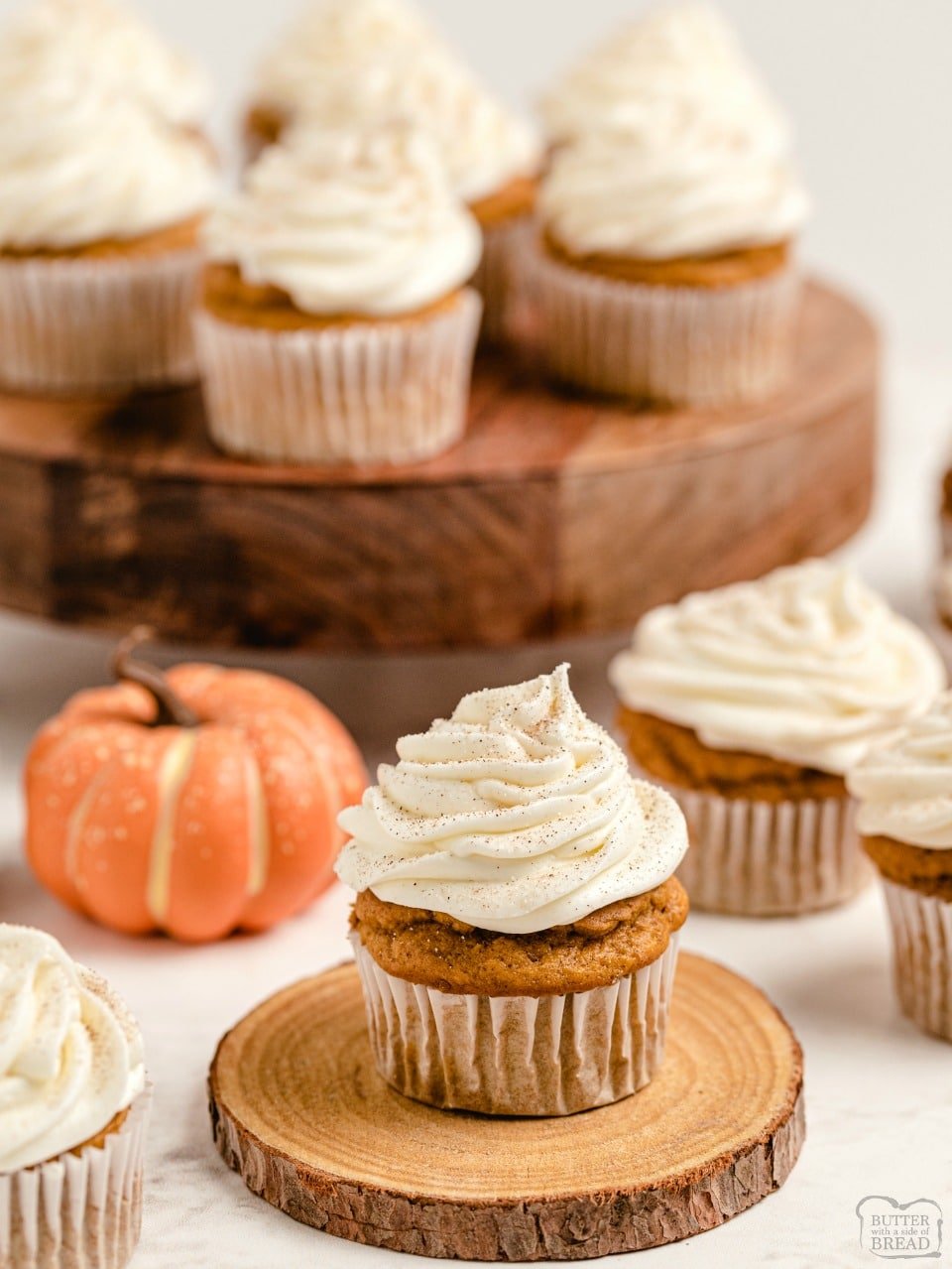Pumpkin Spice Cupcakes with Cream Cheese Frosting are the perfect little treats for celebrating Fall! Easy recipe that starts with yellow cake mix and yields soft, moist perfectly spiced pumpkin cupcakes! 