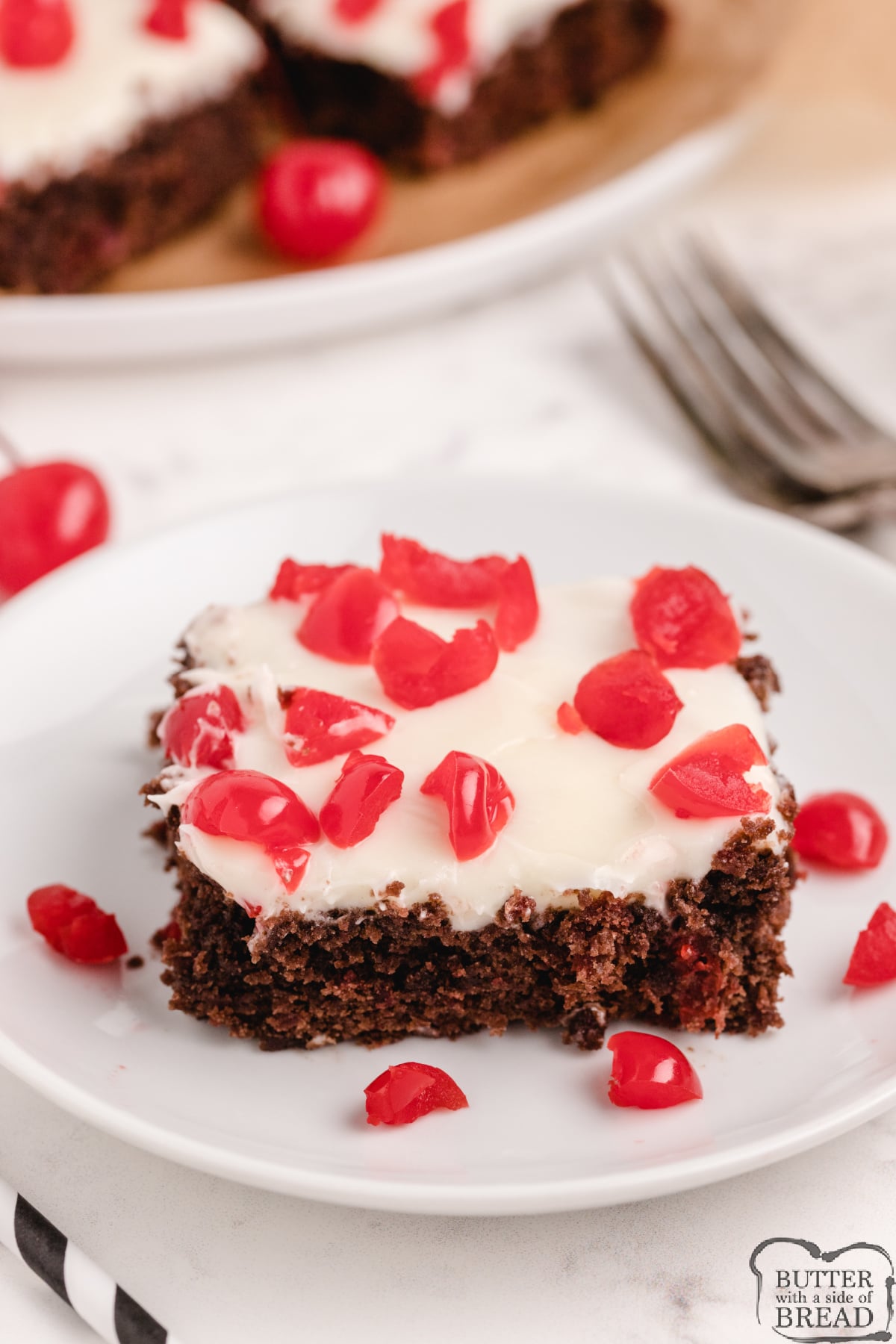 Brownies topped with cream cheese frosting and chopped cherries