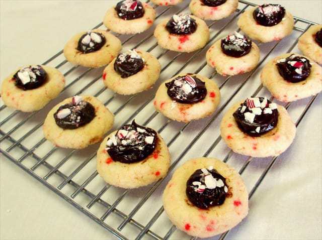 Thumbprint Cookies are so cute and fun to make! When you add delicious fudge and peppermint to them, they are the hit of all of your holiday parties!  
