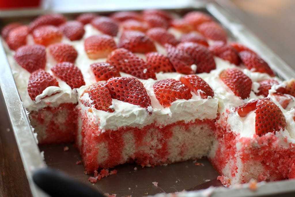 Strawberries & Cream Poke Cake is the perfect light and refreshing dessert for any gathering with family and friends - it is delicious and so pretty!Â 