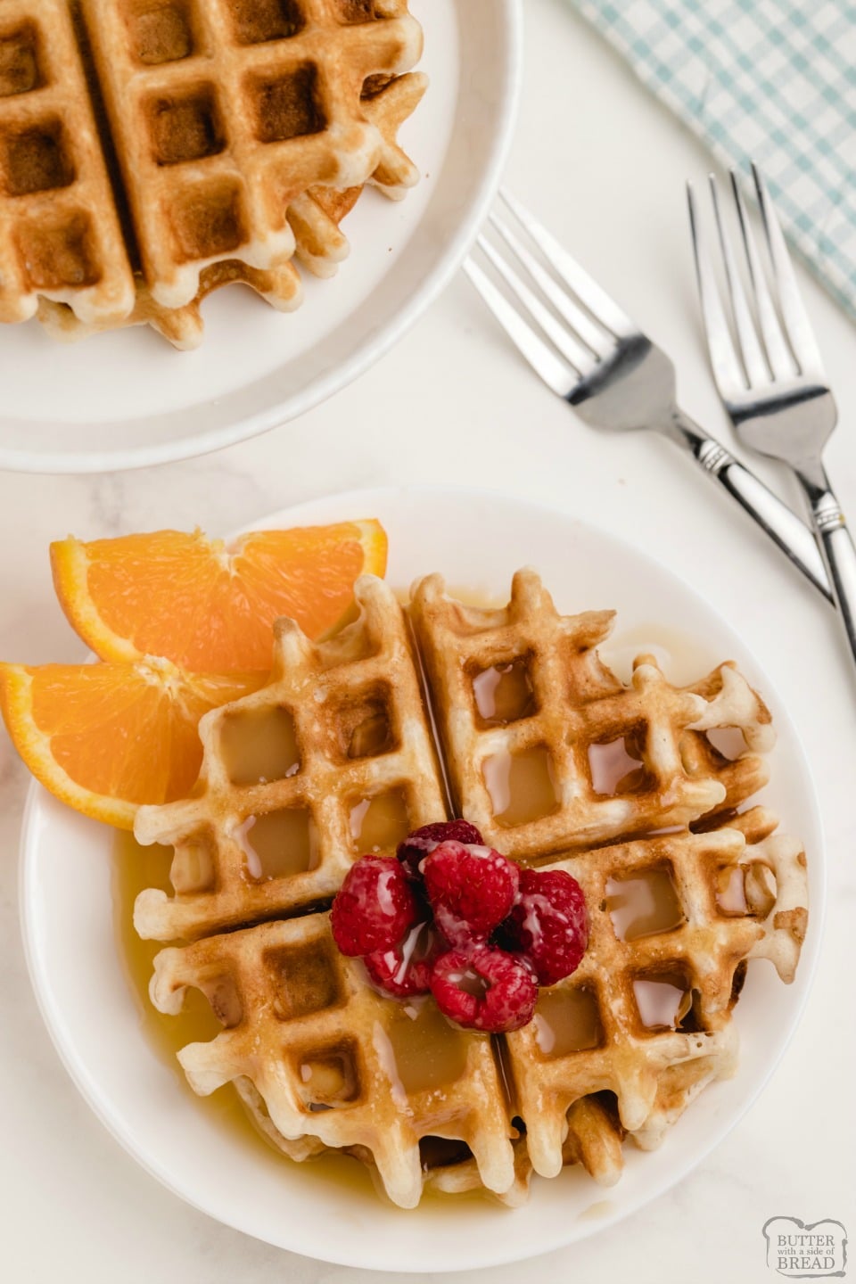 Vanilla Orange Waffles are a sweet citrus waffle served with homemade vanilla butter syrup. Fantastic variation on a traditional waffle recipe that everyone loves!