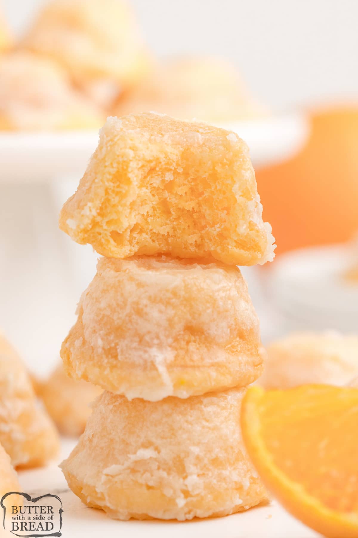 Orange Creamsicle Cake Bites are delicious bite-sized treats that start with a cake mix! The easy orange glaze soaks into the bottoms, making these little cupcakes even more incredible.