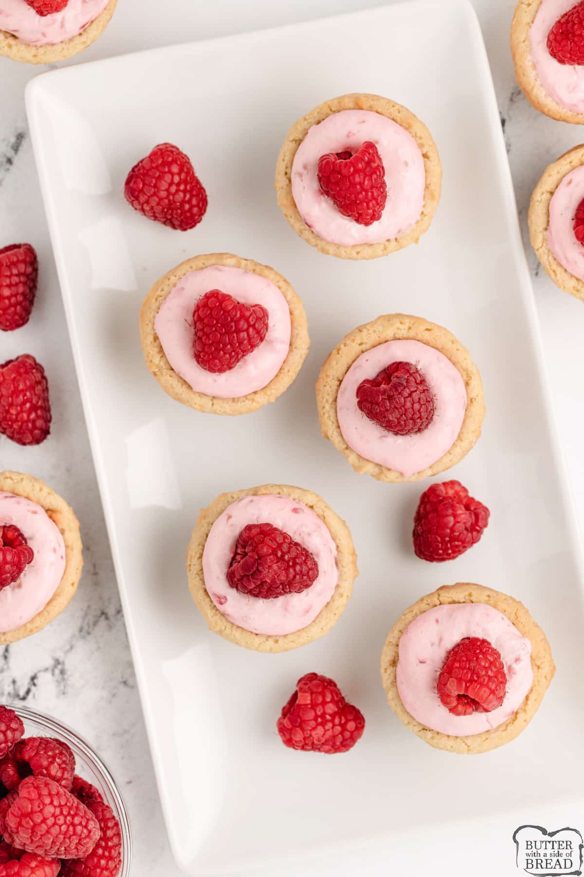 Sugar cookie cups with creamy raspberry filling and a fresh raspberry on top