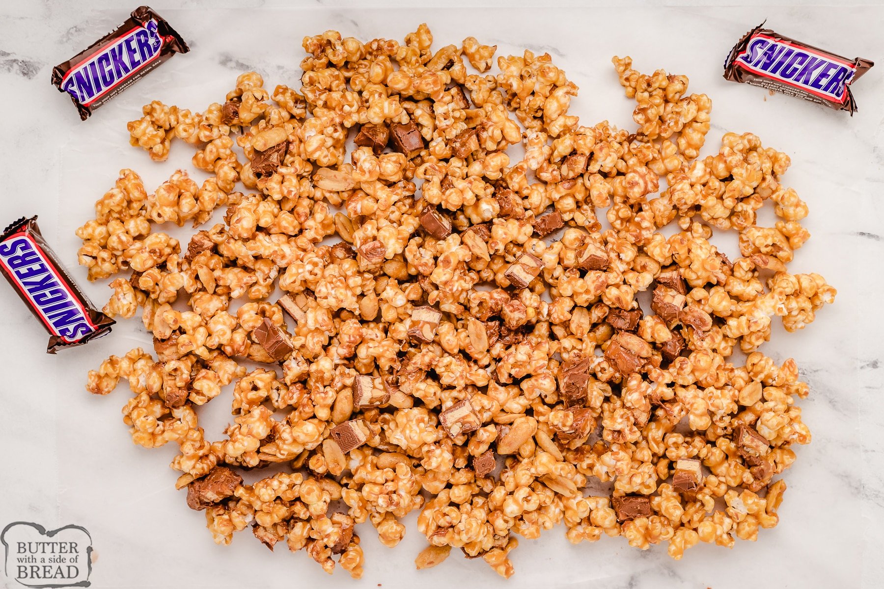 candy coated peanut butter popcorn cooling on wax paper