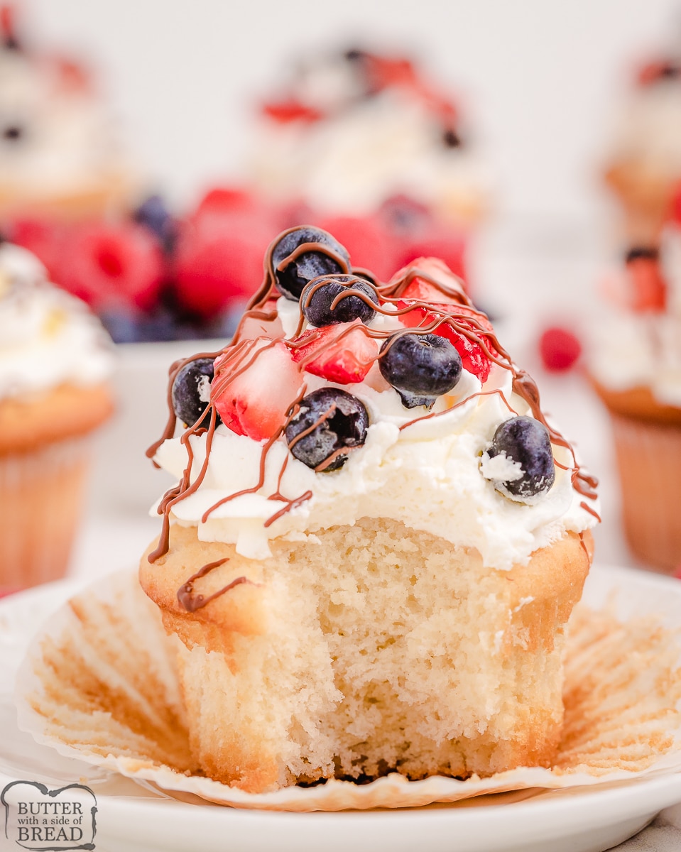 cupcake with berries with a bite taken out of it