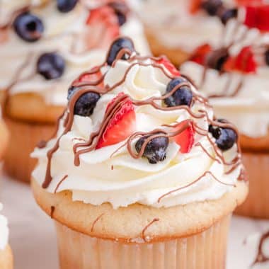 homemade almond cupcakes with berries on top
