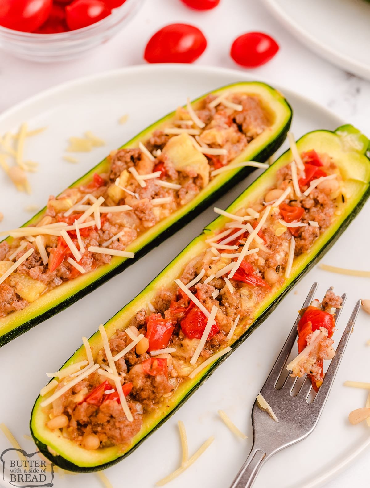 stuffed zucchini made with tomatoes, Parmesan, sausage and pine nuts