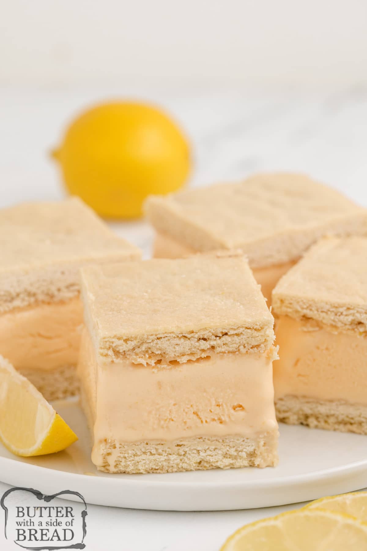 Lemon Ice Cream Bars are made with a delicious lemon ice cream filling sandwiched between two layers of homemade lemon cookie crust. This ice cream sandwich recipe is so simple to make, it makes a perfect summer treat!