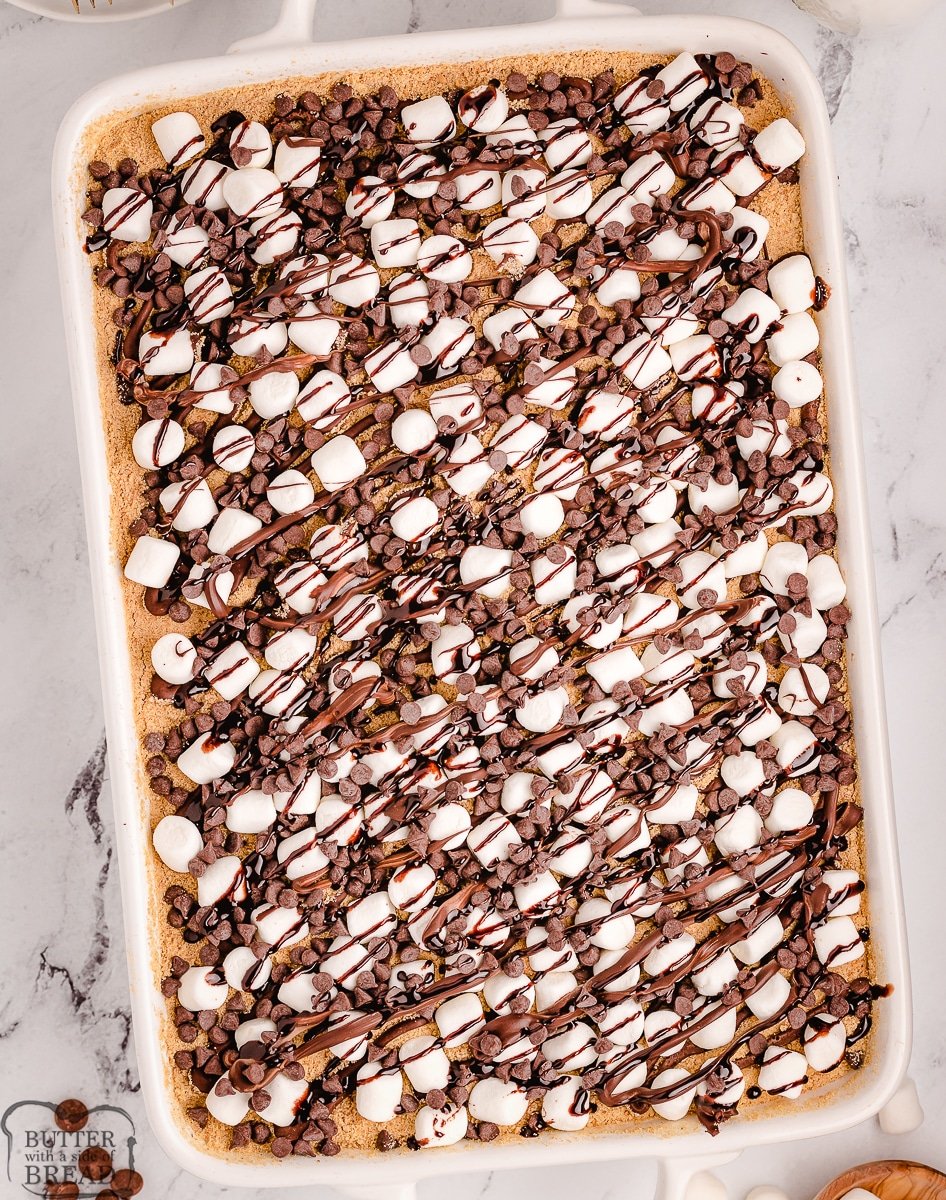 chocolate marshmallow s'mores poke cake in a pan