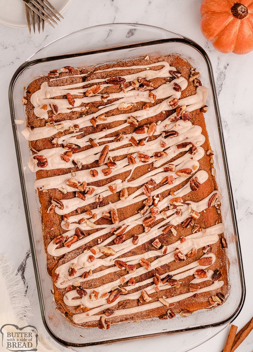pan of pumpkin cheesecake bars with icing on top