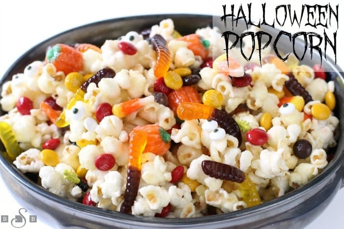 Halloween Popcorn made with a sweet, buttery candy coating then tossed with Halloween candy. It's the perfect festive treat! 
