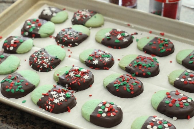 Chocolate Mint Cookies made from a buttery shortbread cookie dipped in dark chocolate & topped with festive holiday sprinkles. My favorite Christmas cookie! 
