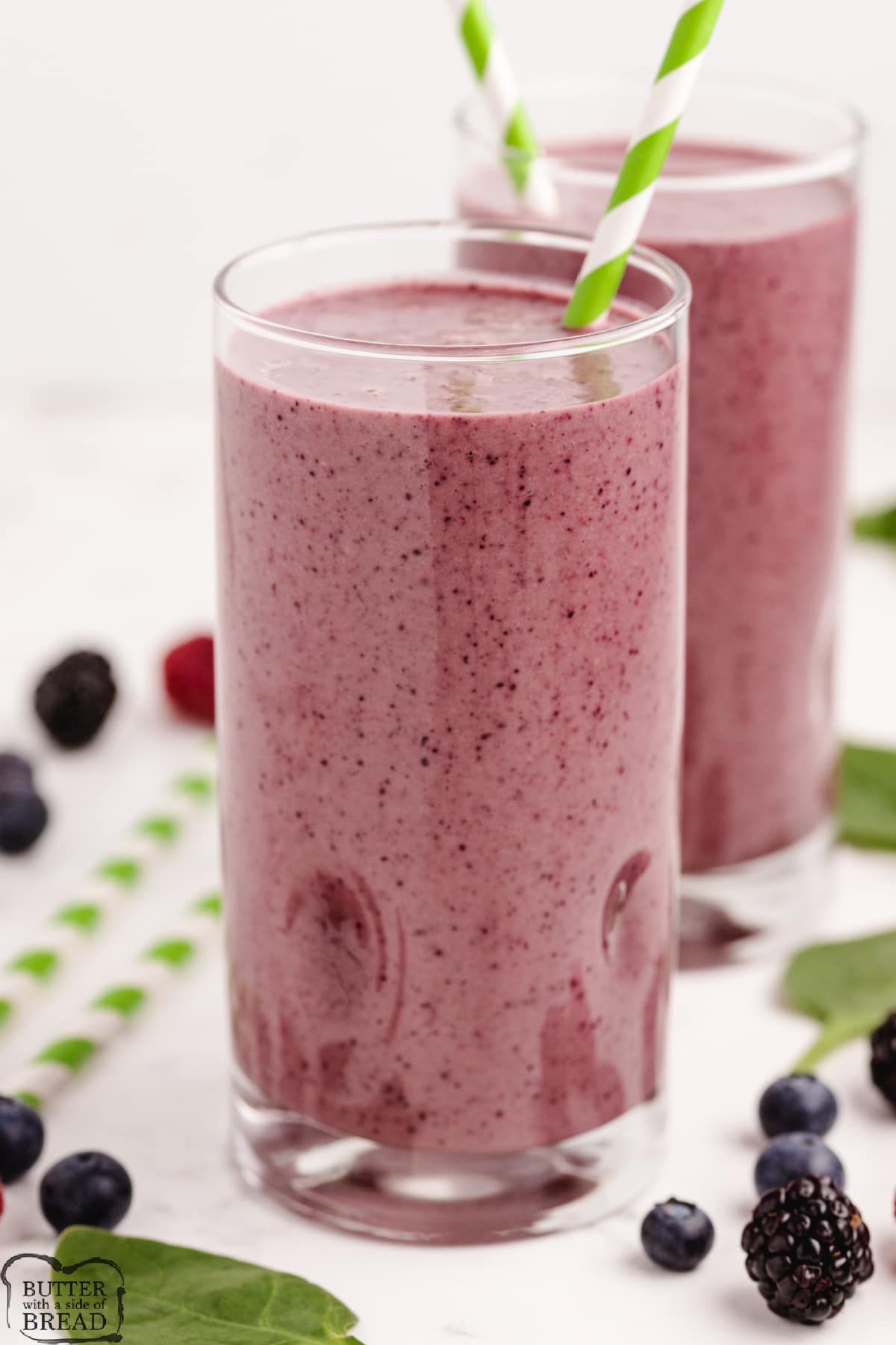 Triple Berry Green Smoothies made with 4 ingredients in less than 2 minutes. Easy smoothie recipe that is so pretty and purple, no one will ever know there is spinach in there! 