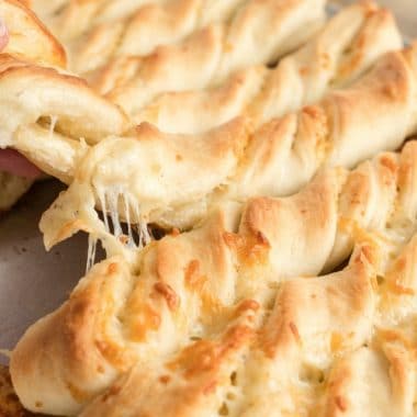 Cheesy breadsticks are a delicious side to a meal and these soft and buttery breadsticks with cheese inside can be made in under an hour!