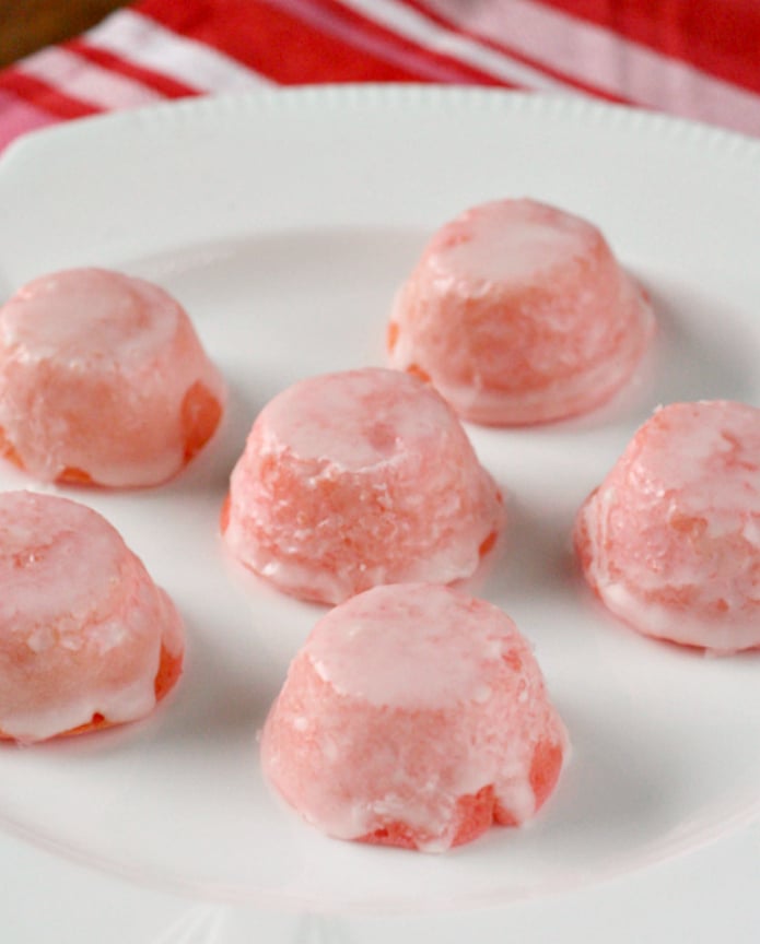 Glazed Mini Strawberry Cupcakes are delicious bite-sized treats that start with a strawberry cake mix. These mini cupcakes are dipped in a simple strawberry glaze to create a strawberries and cream flavor in an easy strawberry cake mix recipe!