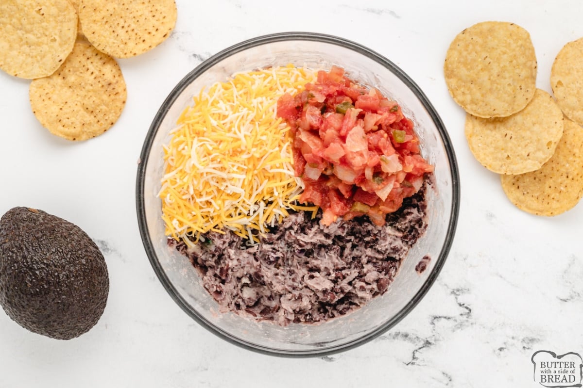 Mixing black beans, salsa and cheese together. 