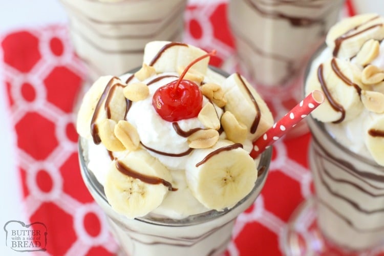 Banana Split Milkshakes made with frozen ripe bananas, milk and vanilla ice cream then topped with salted peanuts, banana slices, whipped cream and a cherry. Perfect banana milkshake recipe for hot summer days.