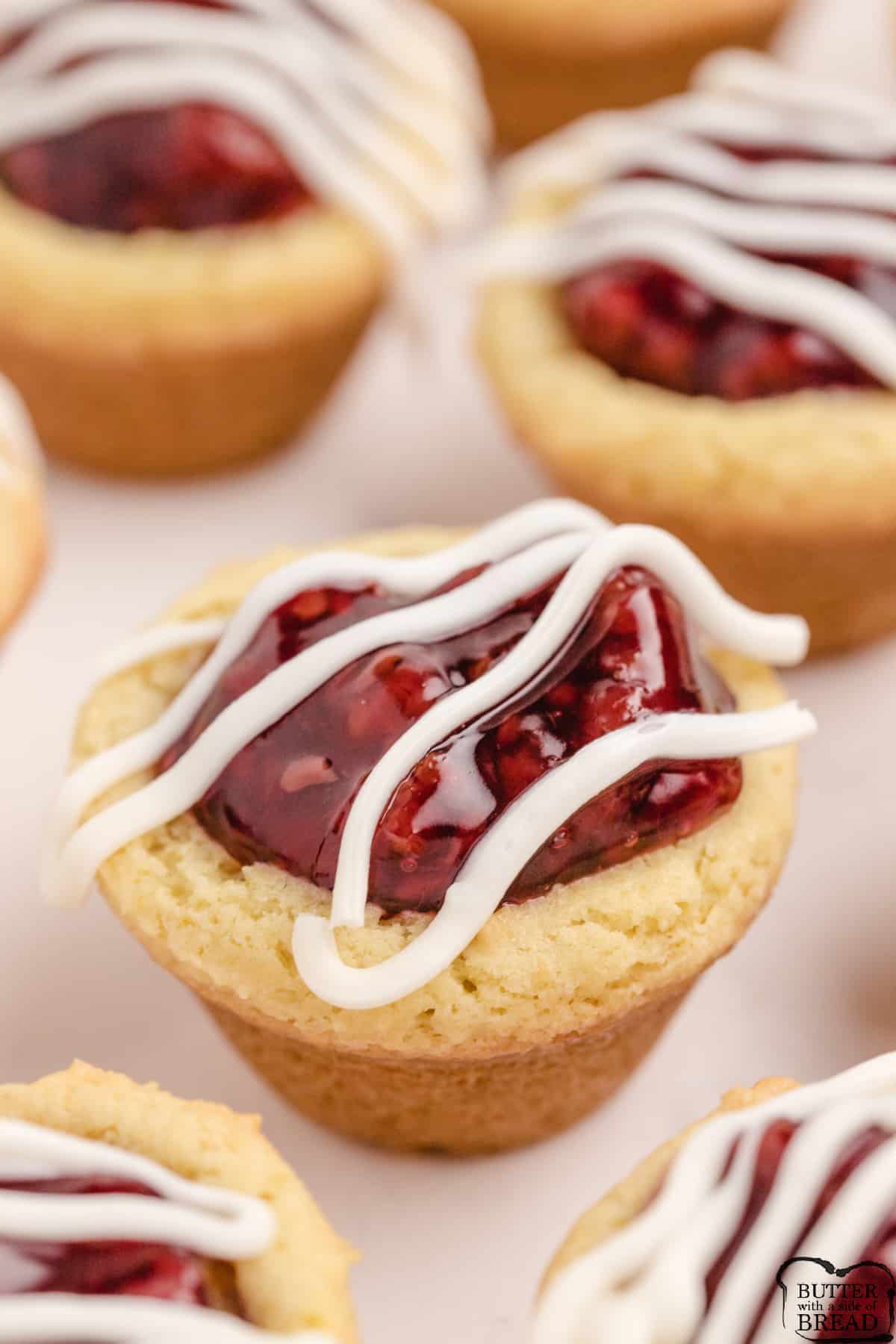 Lemon Raspberry Cookie Cups begin with simple lemon pudding cookie cups that are filled with raspberry pie filling. Simple lemon raspberry cookie recipe that is absolutely delicious. 